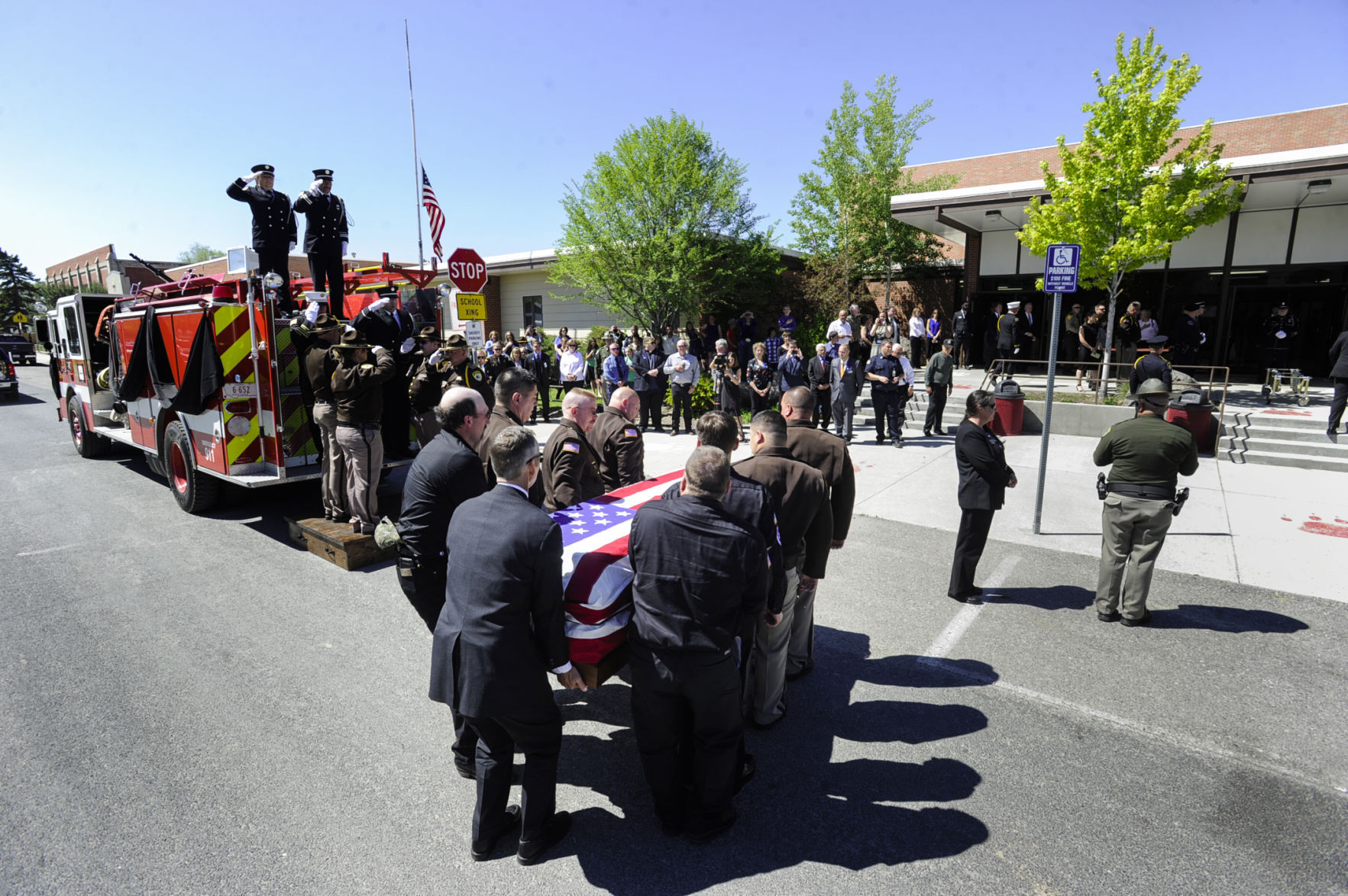 Law enforcement officers carry the casket of Broadwater Deputy Mason Moore into Three Forks High School Tuesday afternoon.